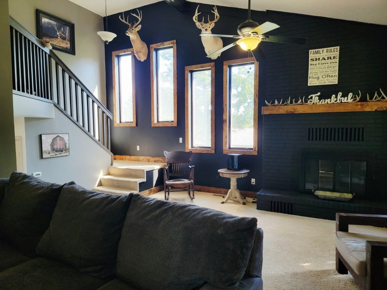 Lodge-style living room with tall windows and fireplace
